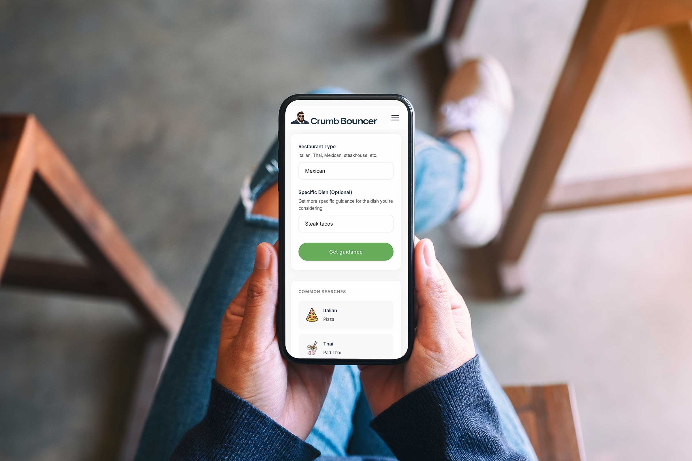 Person holding phone showing the Crumb Bouncer app